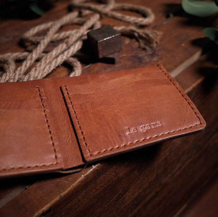 Compact honey brown leather wallet with sleek, minimalist design
