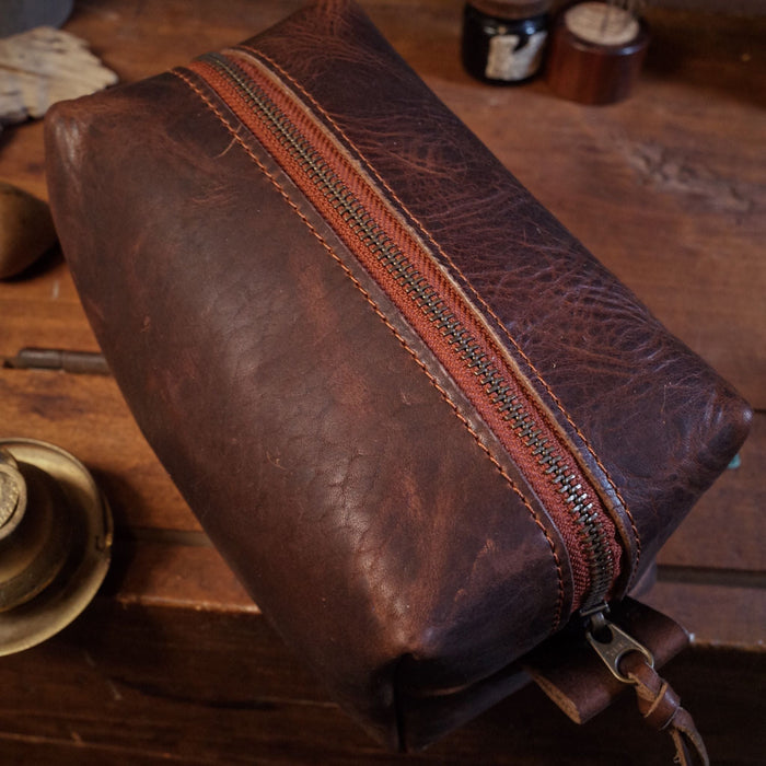 Handmade mocha leather grooming bag with reinforced handle
