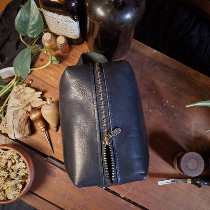 Premium black leather accessory pouch with spacious compartments
