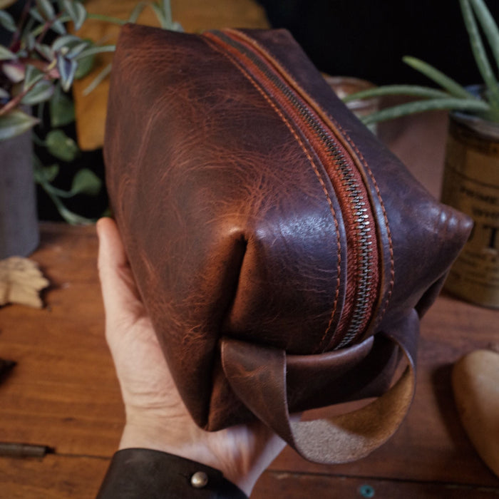 Durable dark-brown leather accessory pouch with high-quality zipper
