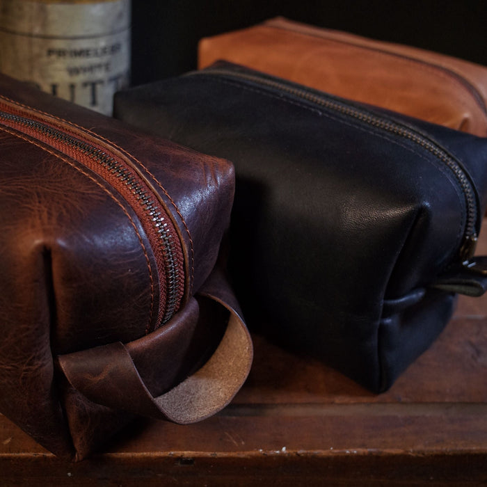 Premium black leather dopp kit with functional interior pockets and zipper
