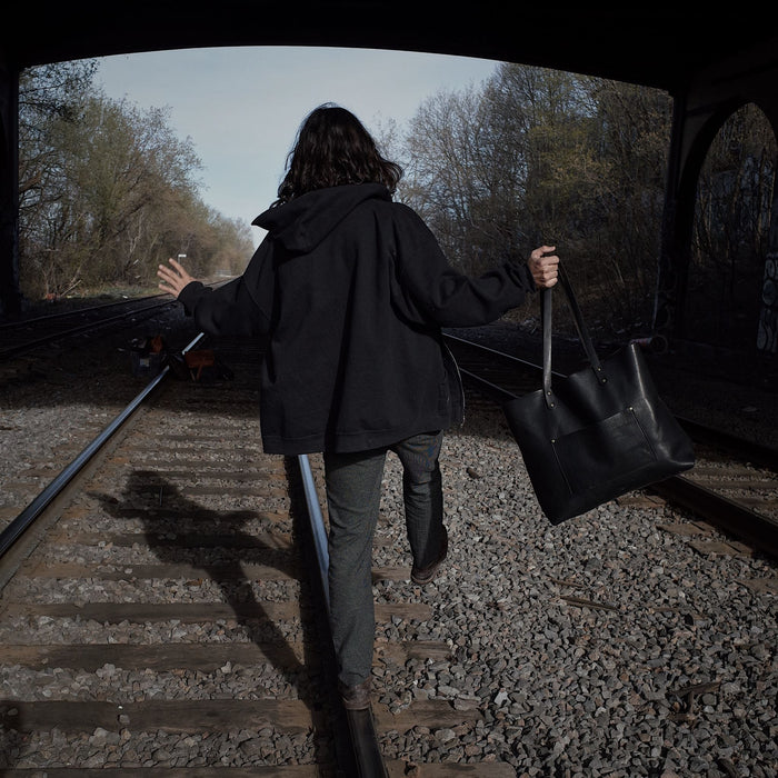 Customizable black leather shopper with durable hand-stitching
