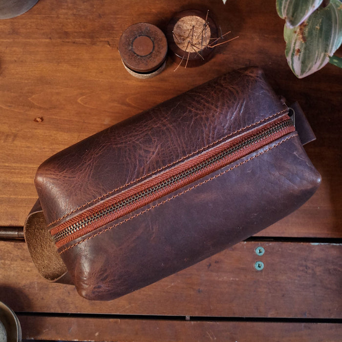Premium dark-brown leather dopp kit with functional interior pockets
