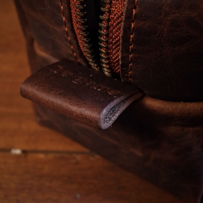 Customizable mocha leather travel bag with premium zipper closure
