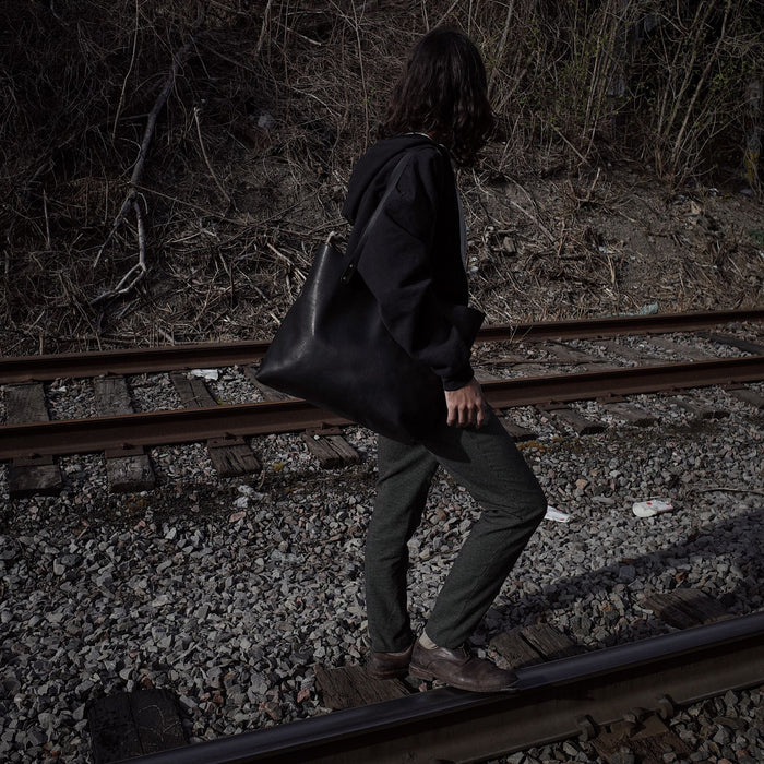 Spacious black leather satchel designed for professionals
