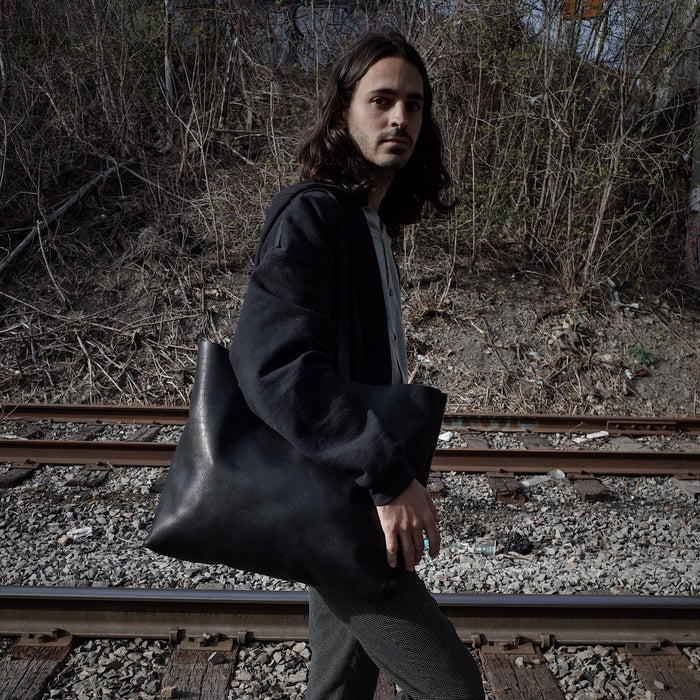 Premium black leather handbag for carrying laptops and more
