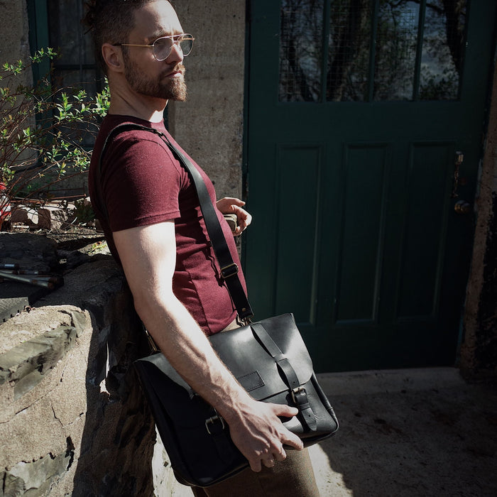 Full-grain black leather briefcase with durable brass hardware
