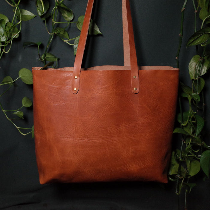 Premium saddle tan leather handbag for carrying laptops and more
