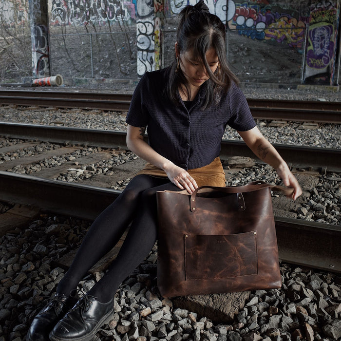 Premium dark-brown leather handbag for carrying laptops and more
