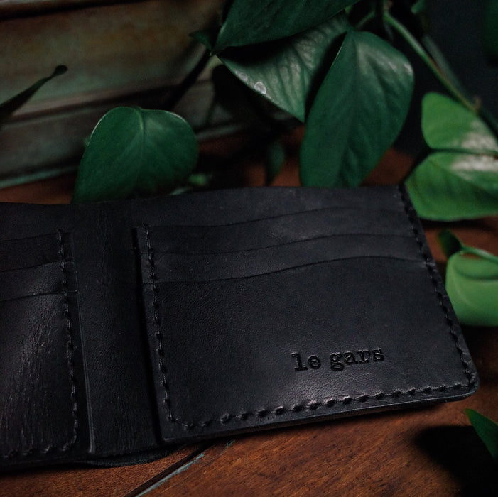 Artisanal black leather wallet with smooth and durable finish
