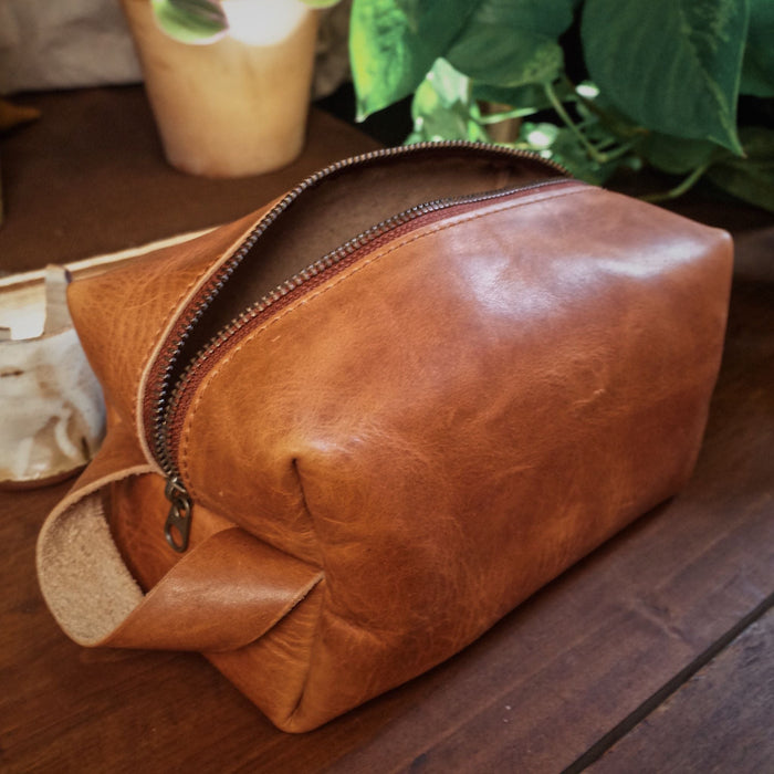 Artisanal light brown leather wash bag with durable stitching
