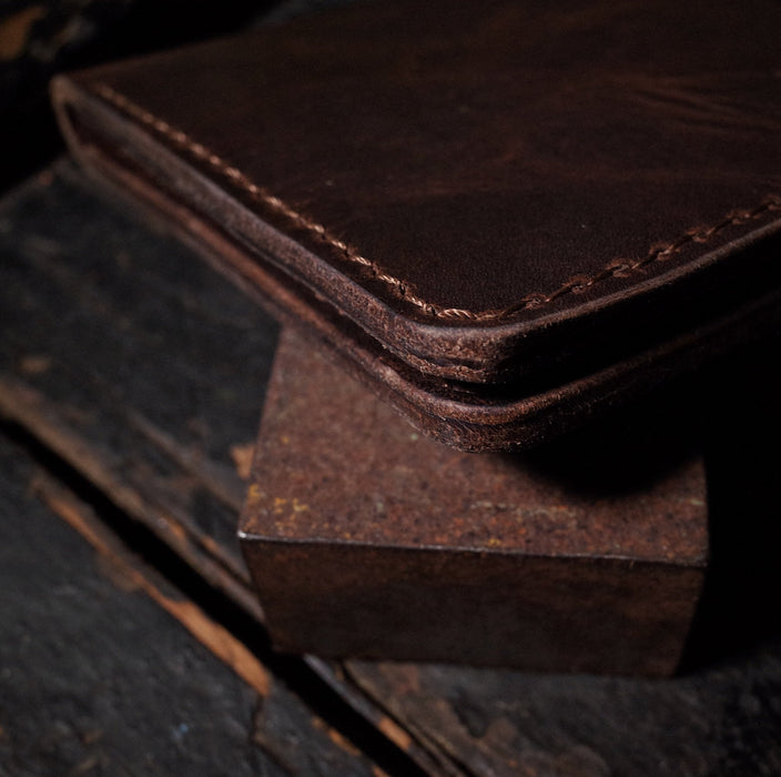Full-grain espresso leather wallet with premium stitching

