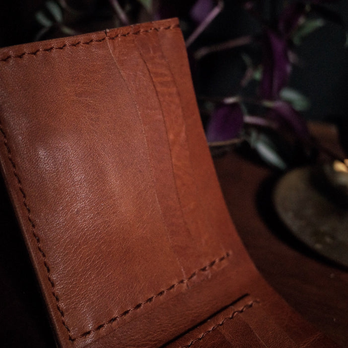 Minimalist honey brown leather bifold wallet with premium materials
