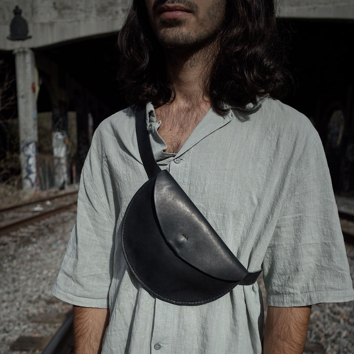 Slim black leather moon bag perfect for small personal items
