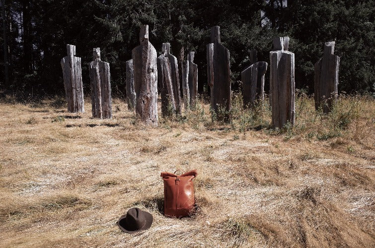 Minimalist caramel leather roll-top backpack for men and women
