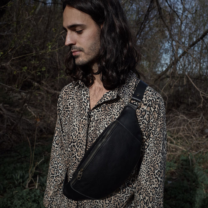 Spacious black leather belt bag with adjustable strap
