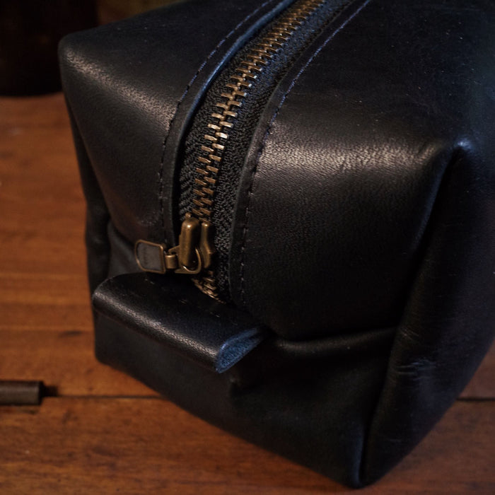 Durable black leather dopp kit with high-quality zipper for long-lasting use
