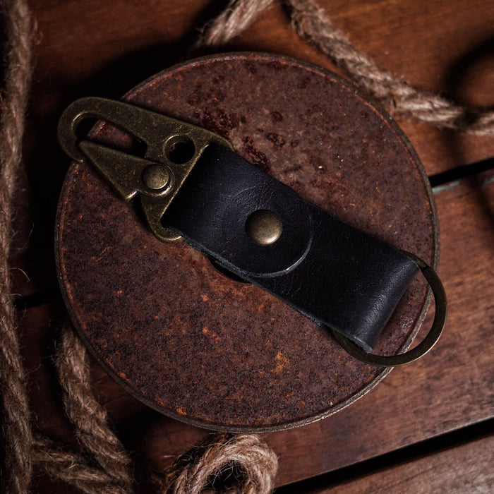 Full-grain black leather key fob with sleek, minimalist design

