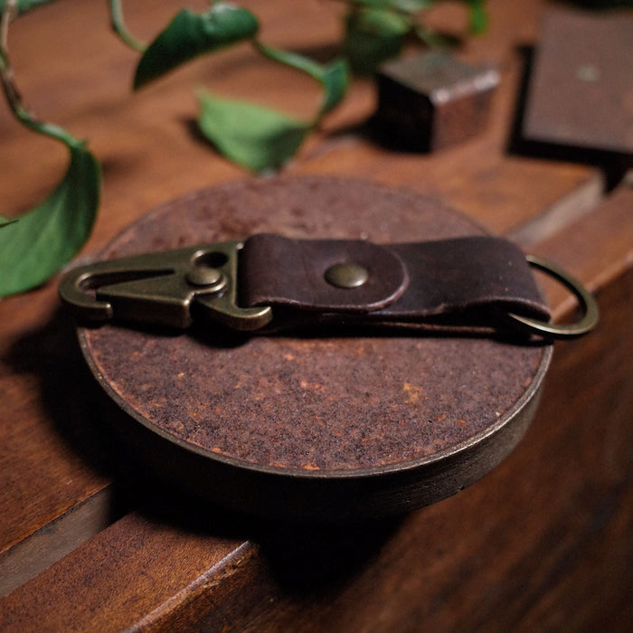 Full-grain chocolate leather key fob with sleek, minimalist design
