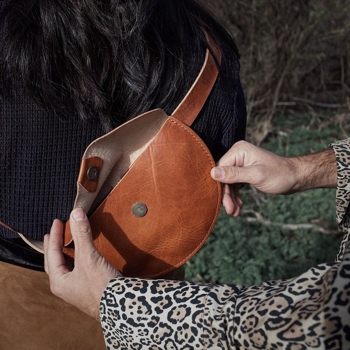 Small saddle tan leather fanny pack designed for lightweight carry
