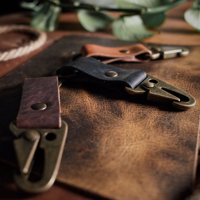 Durable black leather key holder with rugged military-style functionality
