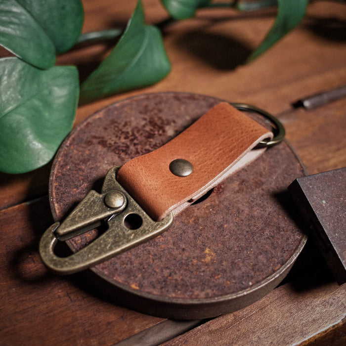 Durable English tan leather carabiner key holder inspired by military style
