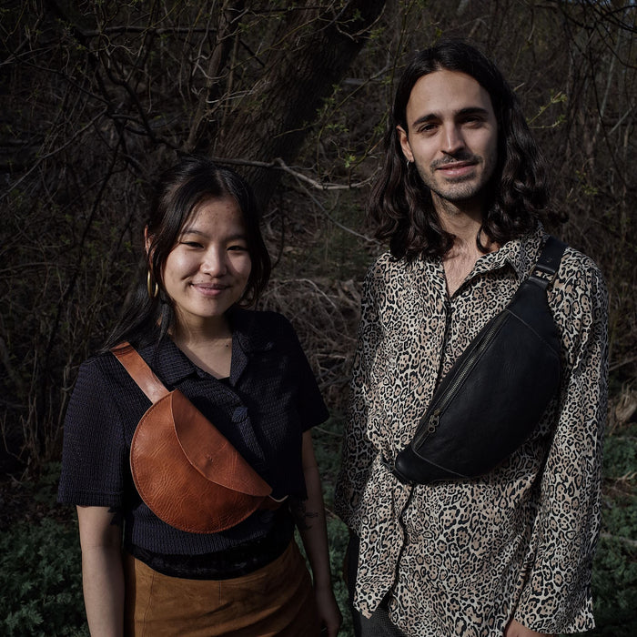 Roomy black leather belt bag with secure zipper closure
