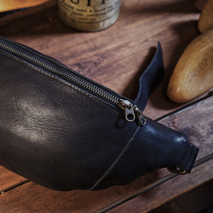 Large black leather belt bag with premium zipper closure
