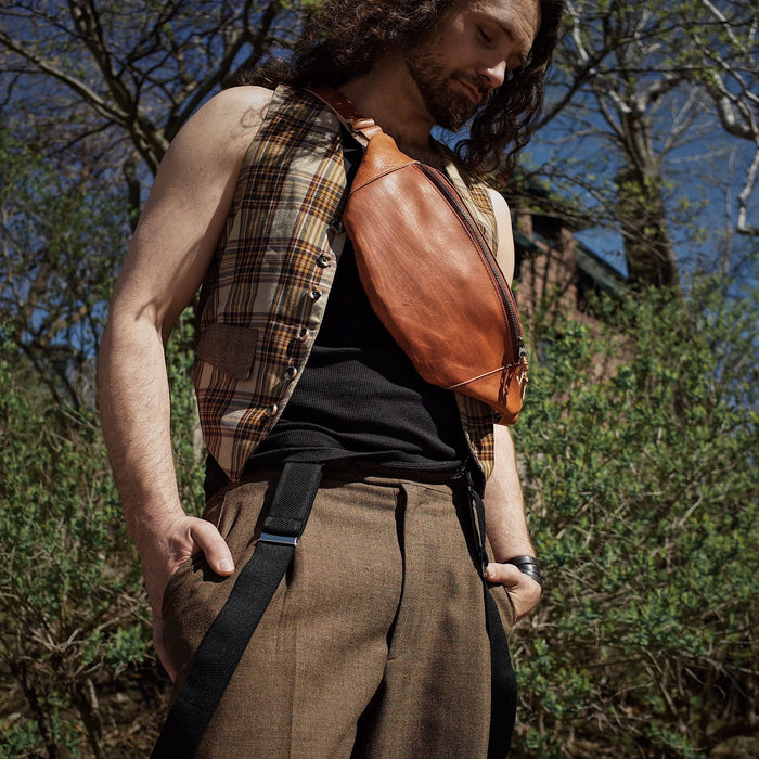 Spacious saddle tan leather fanny pack perfect for travel and events
