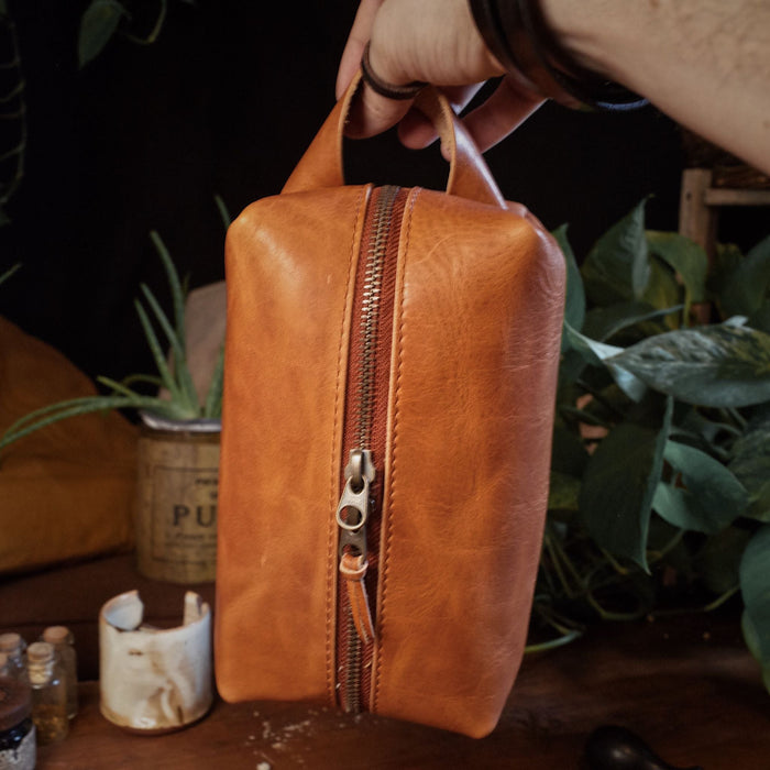 Handmade caramel leather dopp kit with durable metal zipper for long-lasting use
