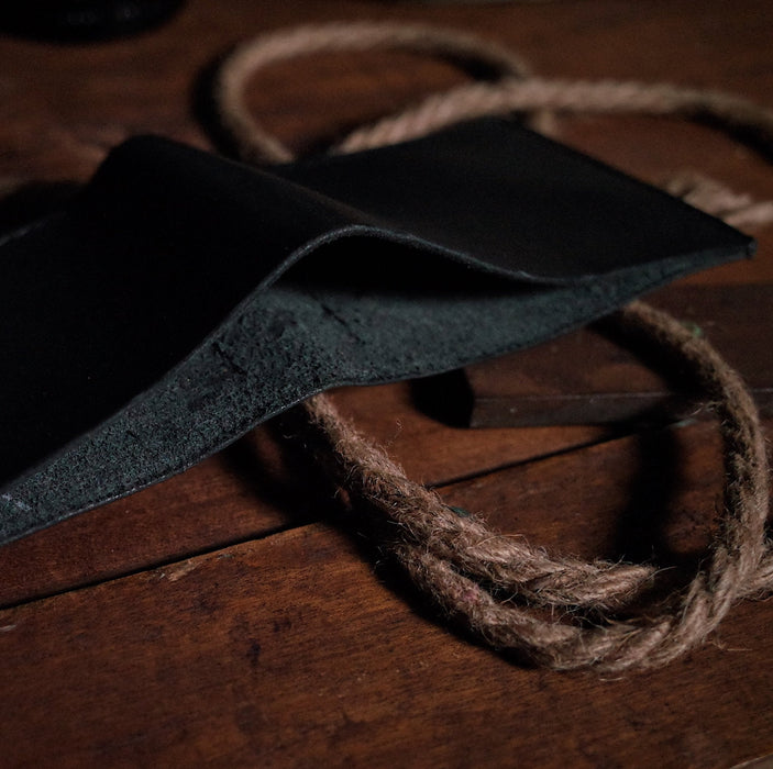 Durable black leather wallet with sleek, minimalist design
