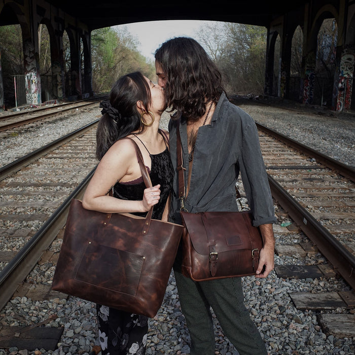 Dark-brown leather satchel with spacious compartments for travel essentials
