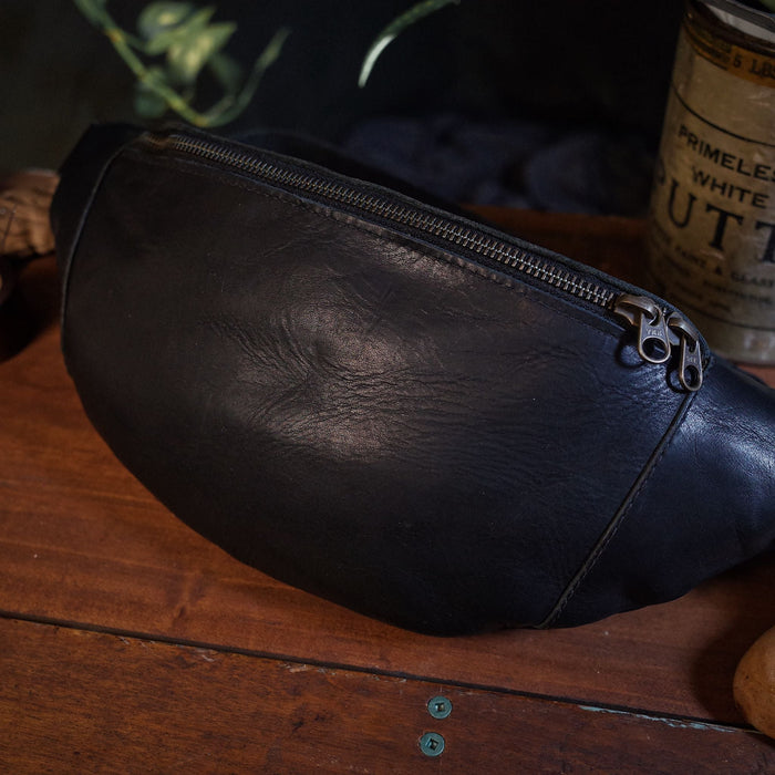 Large black leather waist bag with premium stitching
