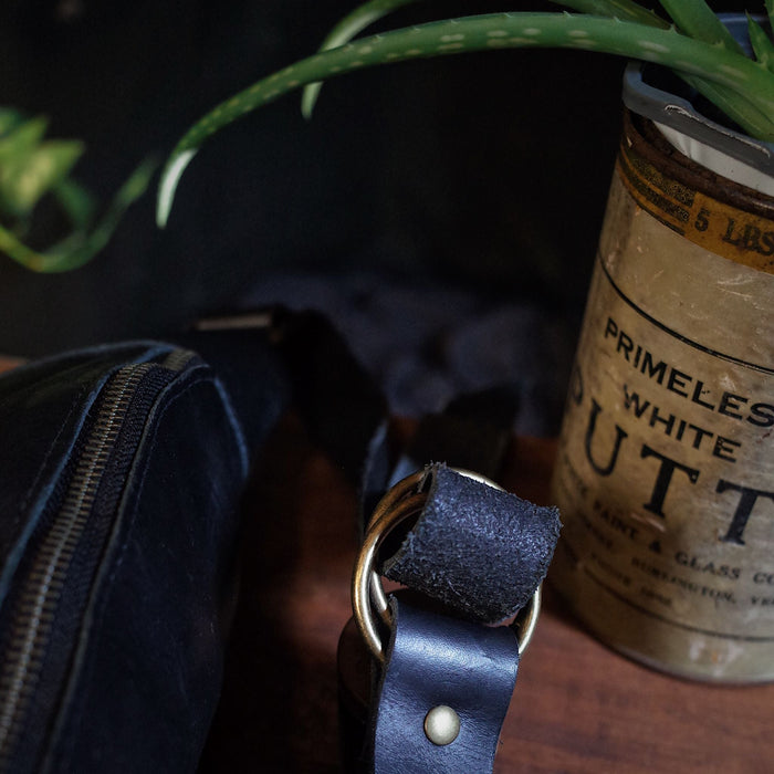 Montreal-made black leather belt bag with multiple zipper pockets
