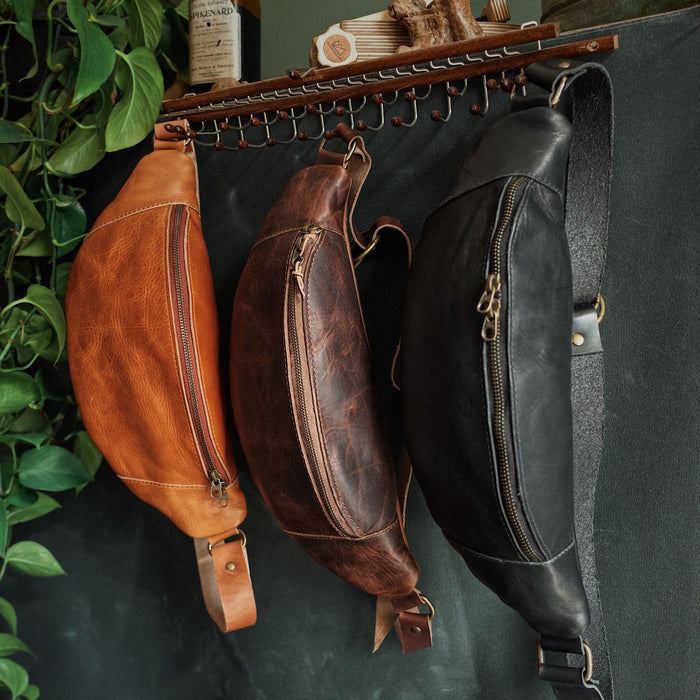 Large black leather fanny pack with multiple zipper pockets
