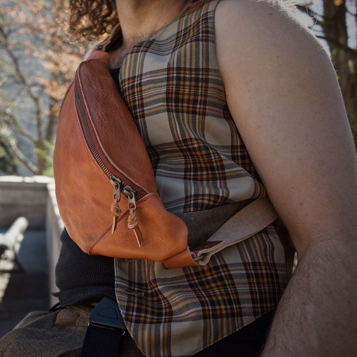 Full-grain English tan leather fanny pack with spacious pockets
