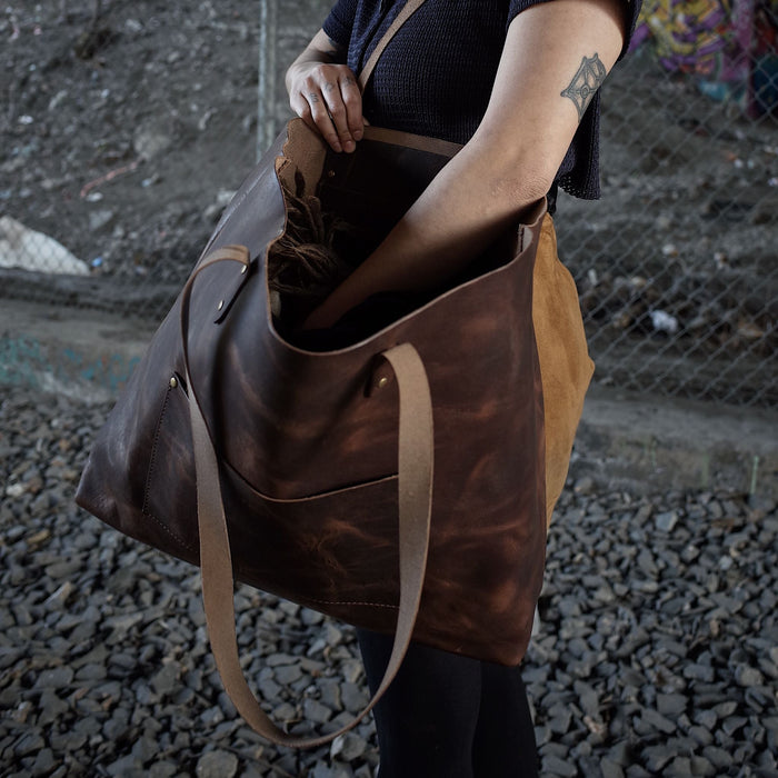 Spacious dark-brown leather handbag designed for durability and functionality
