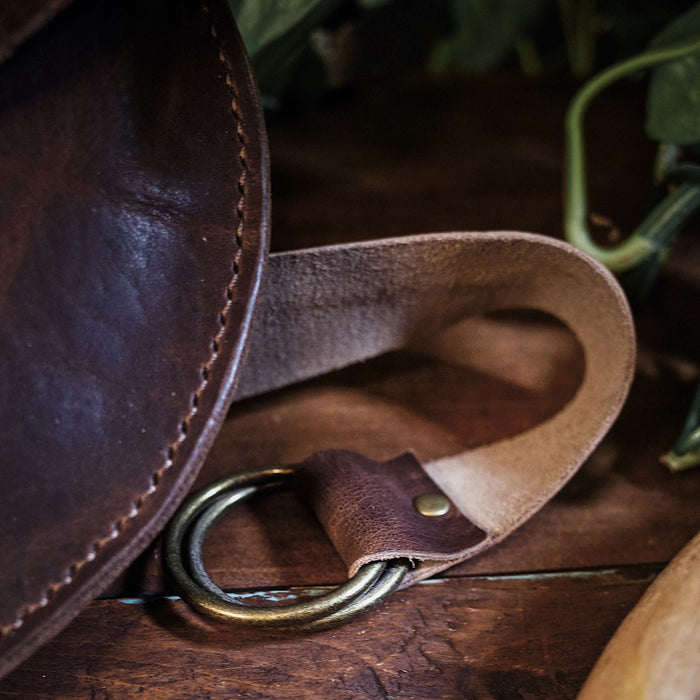 Compact coffee brown leather moon bag for travel essentials
