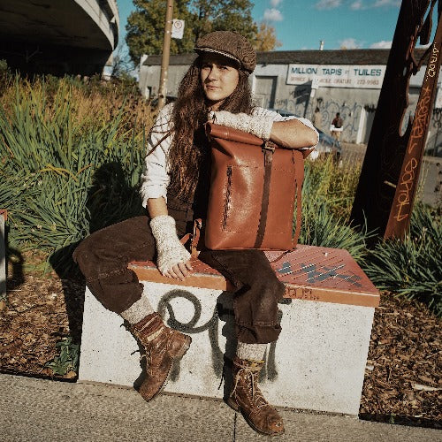 Compact English tan leather roll-top backpack perfect for commuters
