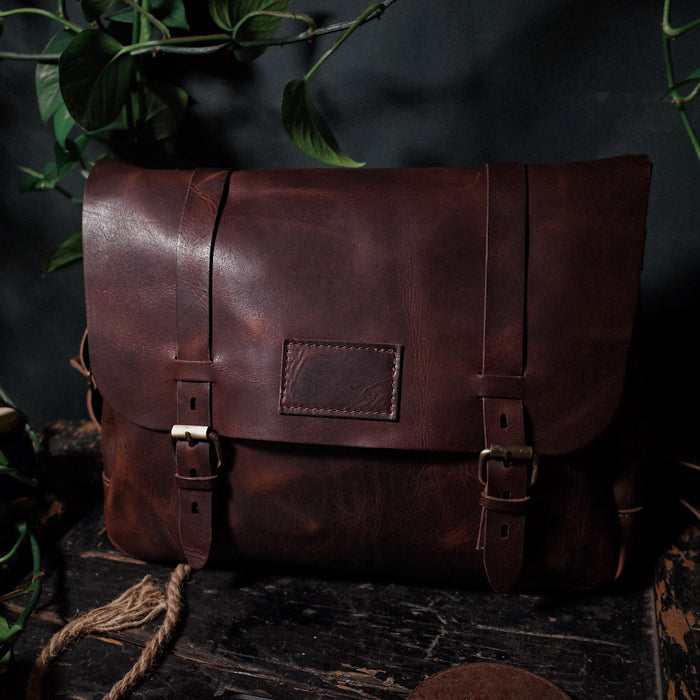 Sustainable dark-brown leather satchel for eco-conscious individuals
