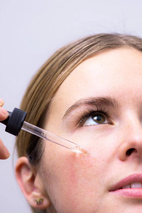 huile hydratante sur visage féminin